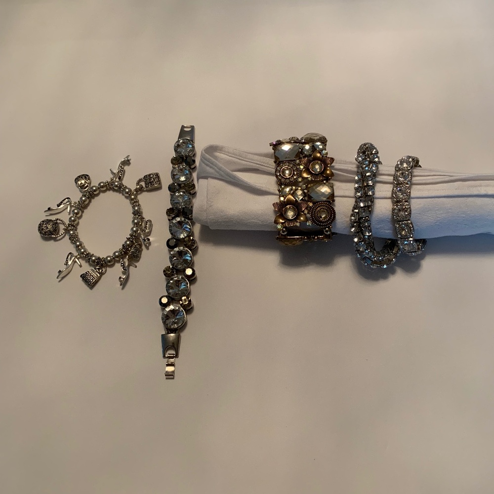Four Silver and Crystal Bracelets and One Bronze and Crystal Bracelet
